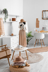 Interior of fashion designer's studio with mannequin, workplace and clothes