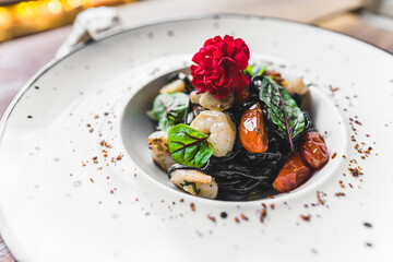 Black Tangliolini with Shrimps modern cuisine with seafood. High quality photo