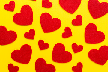 Felt hearts on color background, top view