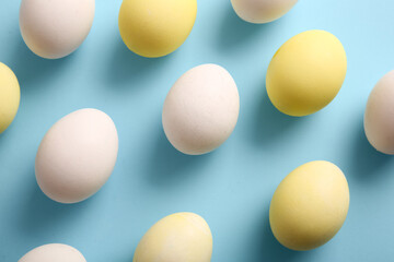 Natural and painted Easter eggs on color background, closeup