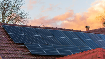 High efficiency half cell solar panels at the top of a family house - 567546963