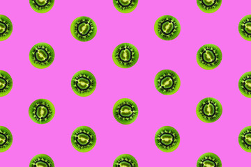 Colorful fruit pattern of fresh kiwi slices on vivid pink background. From top view