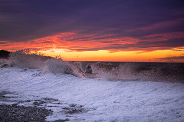 waves hitting the ice dunes of Lake Erie creating more ice dunes. Sunset along the shores of great lake. - obrazy, fototapety, plakaty
