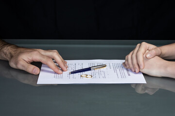 Couple goes through divorce signing papers. High quality photo