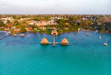 Aerial View at Bacalar city in Quimtana-Roo, Mexico at morning time. Docks on a pillars in a seven...