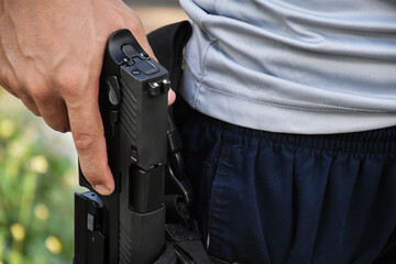 Isolated 9mm pistol gun holding in right hand of gun shooter with clipping paths, copy space.