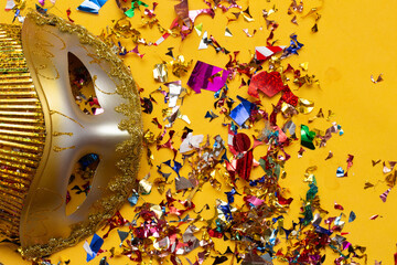 colorful carnival mask on the yellowbackground with several ornaments