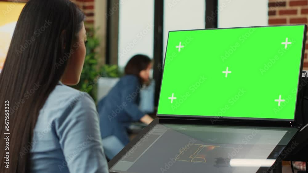 Poster asian woman using game developing software and greenscreen display on monitors. artistic editor work