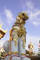Fototapeta premium lion statue in front of the gate of a thai temple