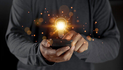 hand holding light bulb. idea concept with innovation and inspiration. Bulb light drawing idea in...