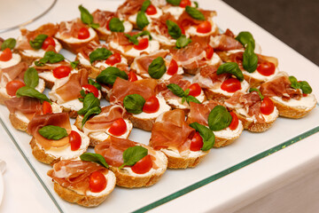 Breakfast in the hotel. Prosciutto sandwiches, close-up.