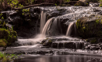 Fototapeta na wymiar Waterfall in the forest close-up