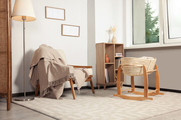 Fototapeta na wymiar Stylish room with wooden furniture and cradle