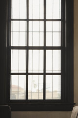 Window with grid on white wall indoors