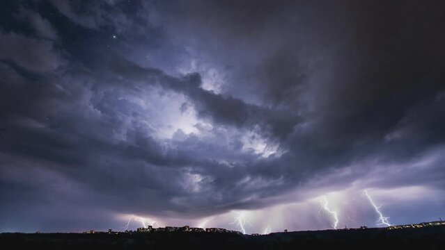 Cinemagraph. Beautiful thunderstorm with clouds and lightning over the night city