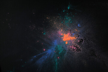 Colorful powder dyes on dark background, top view. Holi festival