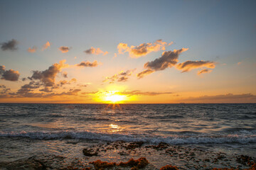 Picturesque view of sea under sky at beautiful sunset