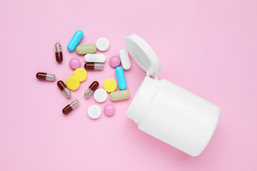 Bottle and antidepressant pills on pink background, flat lay