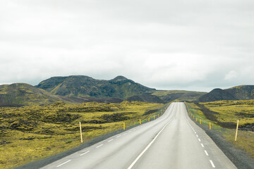 Empty road or highway in the natural environment of Iceland on a cloudy day