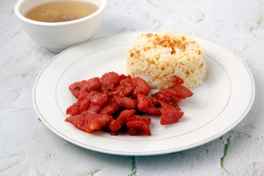 Freshly cooked Filipino food called Tocino or cured pork and fried rice
