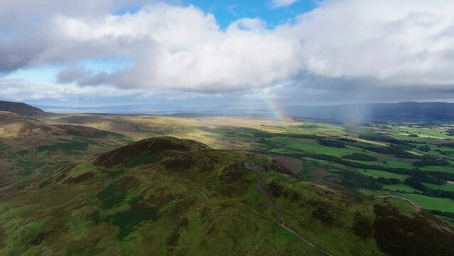 Drone Approach of Conic Hill in Scotland with Rainbow Behind