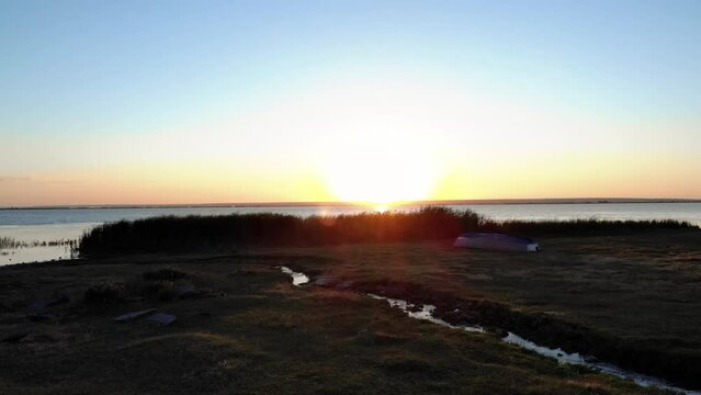 Beautiful Sunrise Over The Calm Waters Of Lake. - aerial forward
