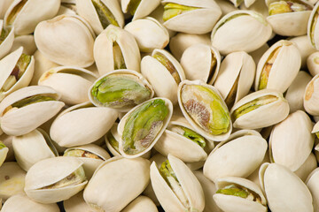 Closeup of peeled pistachio nuts texture background. 