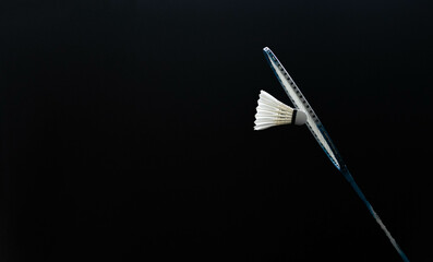 slow motion of the shuttlecock falling on the badminton racket black background black background