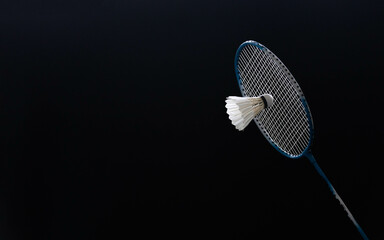 slow motion of the shuttlecock falling on the badminton racket black background black background