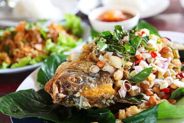 Deep-fried fish with herbs, crispy fish eaten with a spicy dipping sauce that combines various Thai herbs.close-up selective focus