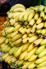 Bananas on the market. Harvest of yellow ripe bananas is sold at the farmer's eco market.