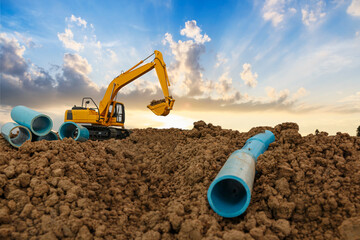Crawler Excavator is digging in the construction site pipeline work in area with sunrise ...