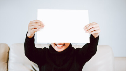 Woman holding blank paper
