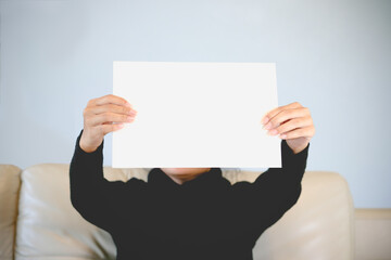 Woman holding blank paper