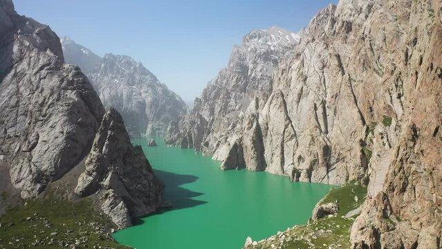 Epic cinematic revealing drone shot of the large ravine surrounding the Kel-Suu lake in Kyrgyzstan