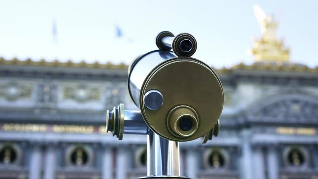 Binoculars telescope overlooking Paris Opera. Popular European travel city, honeymoon destination. Famous landmark in France. 4k slow motion.