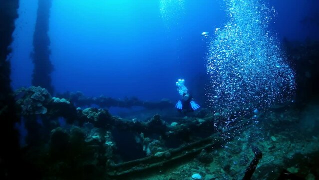 Diving in Truk Lagoon of shipwreck on Chuuk Islands. Ship wreck in sea life of Truk. Inside view of wreck in blue lagoon.