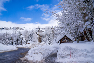 Beautiful snow in Park City, Utah. The small town is a popular winter destination. After the storm, the city is covered in knee-high snow. The snow shines and reflects beautifully when the sun rises