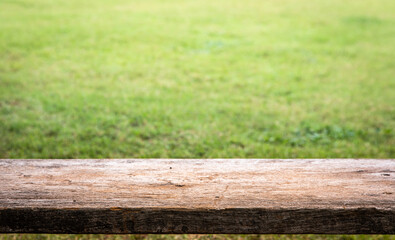 Fototapeta premium wooden floor with grass blur of nature park background and summer for your display montages