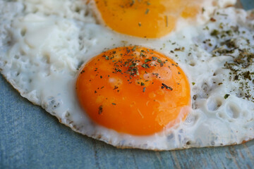 Fried eggs on a plate close up 