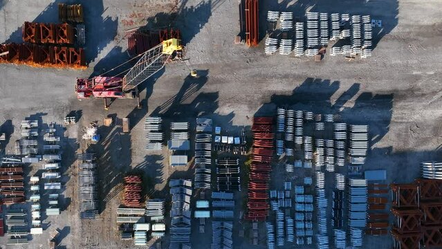 Top down aerial of crane and steel products made in USA manufacturing facility. Import export tariff theme.