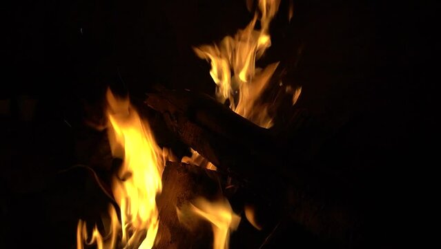 bonfire Close-up, flames from the fire. Night bonfire, logs are on fire, sparks fly. Woods burning in the night time