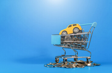 shopping cart on blue background The shopping cart is full in the supermarket. toy shopping cart toy cars on a blue background Copy space for text or design.