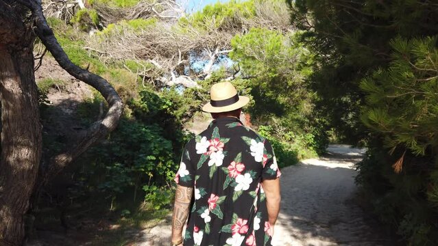 man walking through the dunes of cala agulla