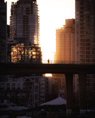 Man walking in city during sunset
