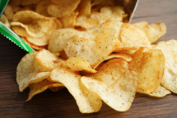 Potato chips in open bag, delicious BBQ seasoning spicy for crips, thin slice deep fried snack fast food in open bag.