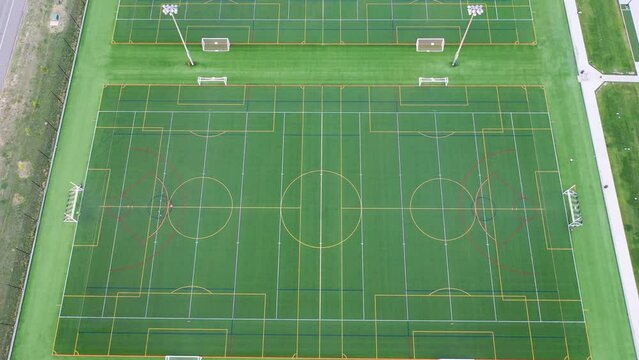 Sports grounds with soccer fields, high angle drone reveal shot