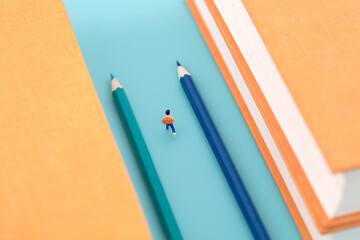 Miniature scene pencil guides the direction of education