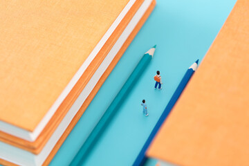 Miniature scene pencil guides the direction of education