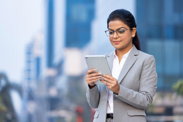 Confident businesswoman using a digital tablet.